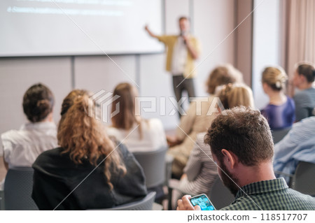 Business presentation with audience in modern conference room setting Business presentation with audience in modern conference room setting 118517707