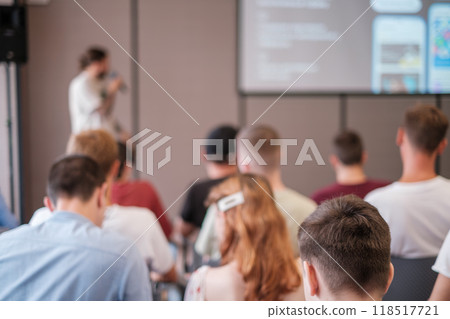 Group of people attending a presentation lecture in a modern conference room Group of people attending a presentation lecture in a modern conference room 118517721