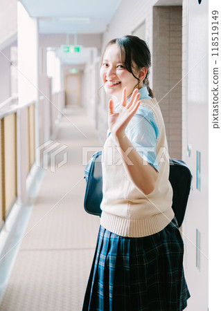 A high school girl in uniform waving to her family at the entrance A high school girl in uniform waving to her family at the entrance 118519149