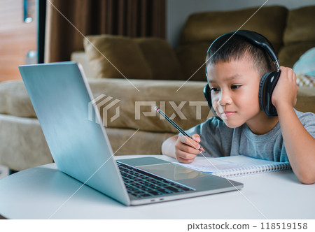 Online education, Technology studying at home using laptop computer, Student distance learning virtual distance online class on video call virtual lesson, Teaching child boy with remote education. Online education, Technology studying at home using laptop computer, Student distance learning virtual distance online class on video call virtual lesson, Teaching child boy with remote education. 118519158