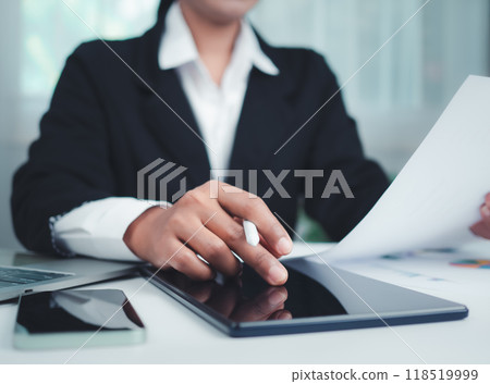 Business Woman in black suit working on tablet, Paper documents and laptop, Hands touch on tablet at office with white background, Online working, Close up, Copy space. 118519999