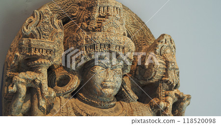 Close Up View On Statue Of Bhairava Or Frightful, Or Kala Bhairava, Is Shaivite And Vajrayana Deity Worshipped By Hindus And Buddhists. Antique Museum Piece Of Hoyasala Period, Karnataka 12th Century Close Up View On Statue Of Bhairava Or Frightful, Or Kala Bhairava, Is Shaivite And Vajrayana Deity Worshipped By Hindus And Buddhists. Antique Museum Piece Of Hoyasala Period, Karnataka 12th Century 118520098