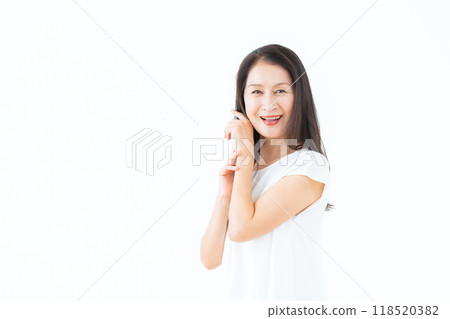 Middle-aged woman doing skin care Middle-aged woman doing skin care 118520382