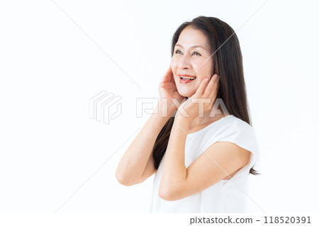 Middle-aged woman doing skin care Middle-aged woman doing skin care 118520391