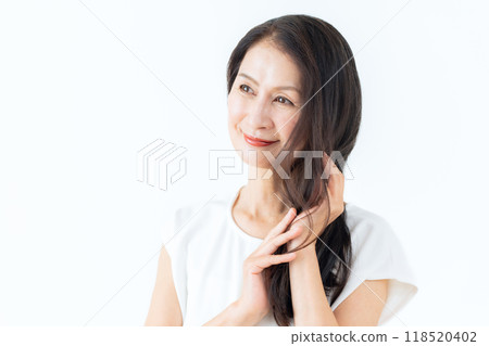 Middle-aged woman doing skin care Middle-aged woman doing skin care 118520402