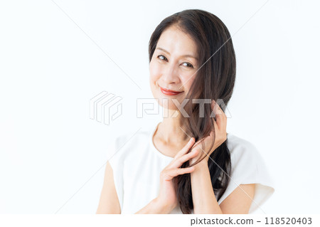 Middle-aged woman doing skin care Middle-aged woman doing skin care 118520403