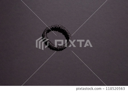 Hair scrunchie for women, crafted from natural materials in a solid color design. Versatile and stylish accessory for various hairstyles 118520563