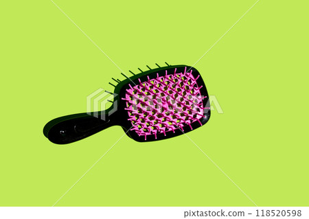 black plastic hairbrush on green background 118520598