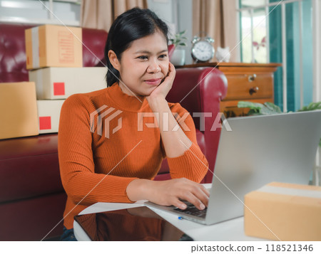Asia women working business SME online at home her checking order from laptop for customer and online delivery for ready packing, Checking orders from customers with digital laptop, Small business. Asia women working business SME online at home her checking order from laptop for customer and online delivery for ready packing, Checking orders from customers with digital laptop, Small business. 118521346