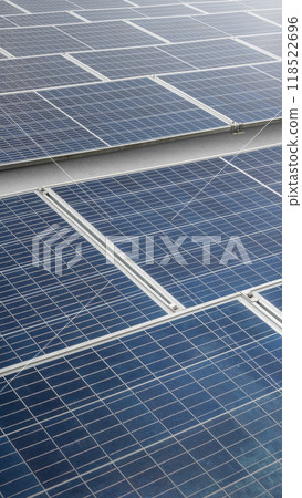 A solar panel or solar cell is shown in a close up. The panel is blue and has a grid pattern. Photovoltaic module 118522696