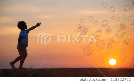 A nostalgic scene of a child and soap bubbles at sunset 118522762