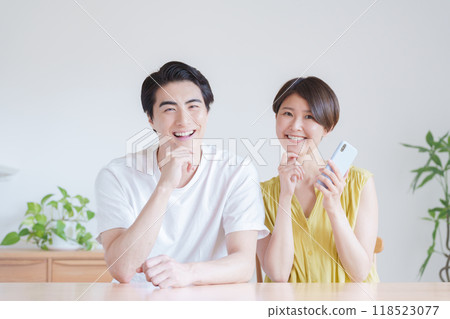 A couple using a smartphone A couple using a smartphone 118523077