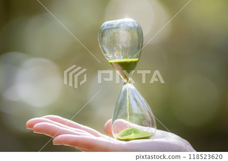 Person with hourglass in the forest 118523620