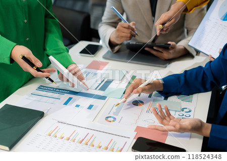Co working team meeting concept: Business team working and studying together with tablet document graph paper in office, discuss finance and marketing solution reporting file in working place. 118524348