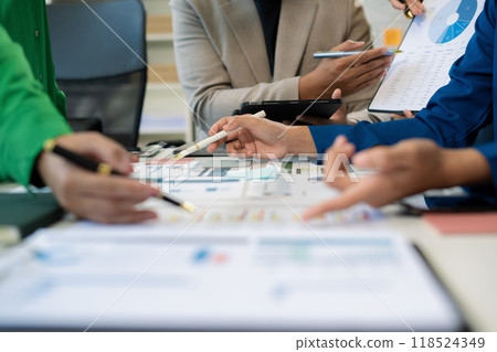 Co working team meeting concept: Business team working and studying together with tablet document graph paper in office, discuss finance and marketing solution reporting file in working place. 118524349
