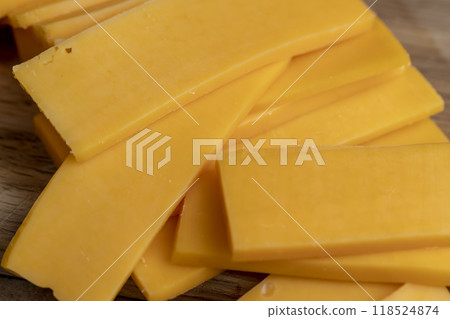 slicing yellow cheese close-up 118524874