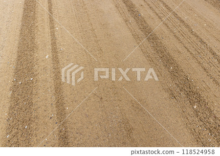 close-up of a part of a wet road without asphalt close-up of a part of a wet road without asphalt 118524958