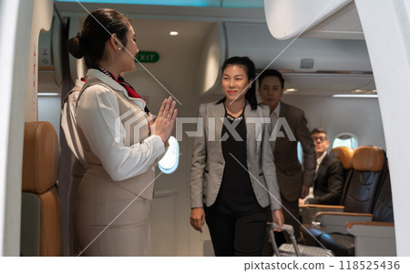Air hostess or flight attendant standing at airplane entrance door and greeting passengers leaving airplane cabin Air hostess or flight attendant standing at airplane entrance door and greeting passengers leaving airplane cabin 118525436