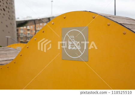 Sign with crossed out roller on decorative structure for people to sit on. Do not use structure in the park as ramp, roller skating safety without tricks Sign with crossed out roller on decorative structure for people to sit on. Do not use structure in the park as ramp, roller skating safety without tricks 118525510