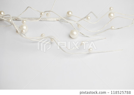 White branches with shiny pearl on white background. Christmas and New Year theme 118525788