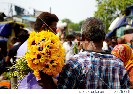 Sunflower Seller fond of Buyer in Howrah Flower market in Morning Sunflower Seller fond of Buyer in Howrah Flower market in Morning 118526856