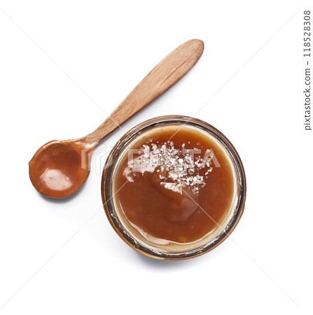 Caramel sauce top view on white backgrounds Caramel sauce top view on white backgrounds 118528308