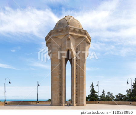 Eternal Flame Monument in Baku, Azerbaijan stands tall against a backdrop of a clear blue sky 118528990