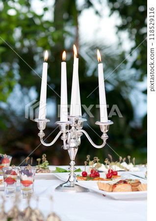 Catering buffet table with snacks and appetizers and candles Catering buffet table with snacks and appetizers and candles 118529116