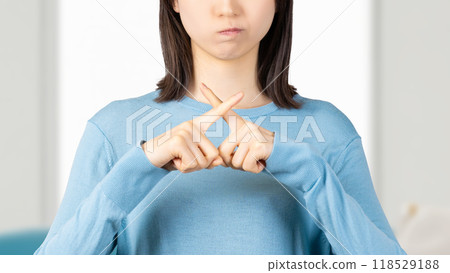 An angry woman making an X sign with her fingers 118529188