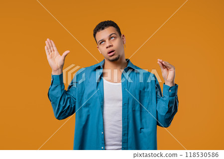Irritated young multiracial man showing bla-bla gesture with hands, rolling eyes Irritated young multiracial man showing bla-bla gesture with hands, rolling eyes 118530586