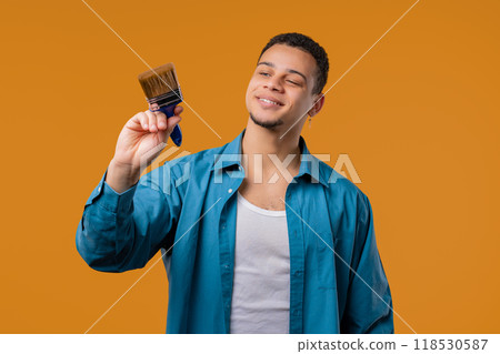 Creative painter artist man with brush on Yellow background. Fantasy, idea 118530587