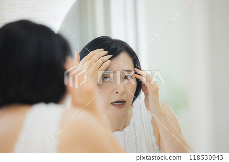 Middle-aged woman doing skin care 118530943