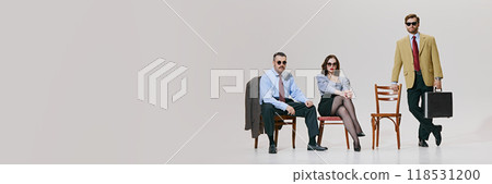Banner. Business experts seated with air of authority, showcasing classic business style with modern against white background with copy space. Banner. Business experts seated with air of authority, showcasing classic business style with modern against white background with copy space. 118531200
