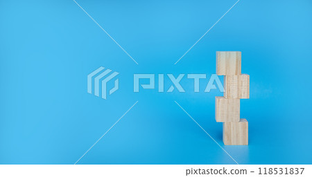 Cubic wooden block stacked on a blue background 118531837