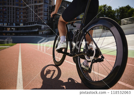 Closeup view on male bicyclist pedaling riding bike over sprint tack 118532063