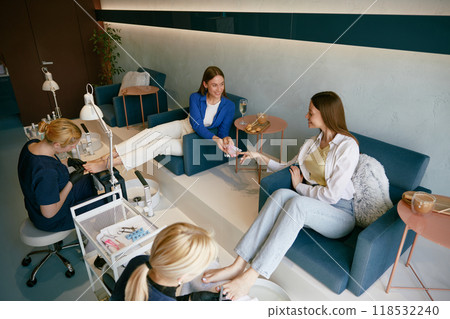Young woman friends gossiping whispering secrets at nail studio 118532240