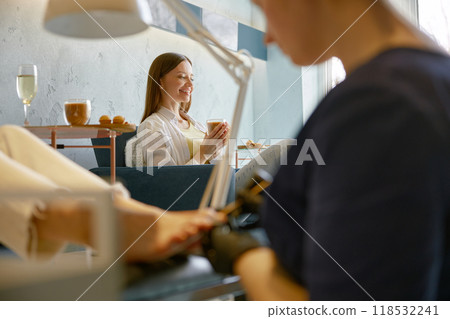 Young woman friends gossiping whispering secrets at nail studio 118532241