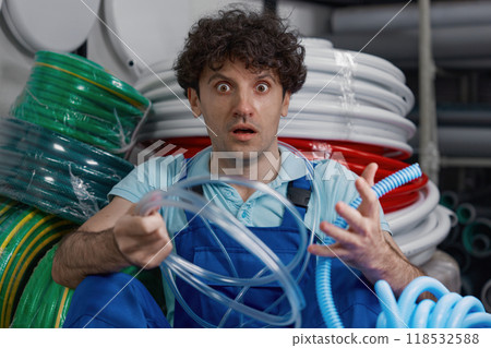 Crazy plumber shouting while sitting at plumbing shop floor Crazy plumber shouting while sitting at plumbing shop floor 118532588