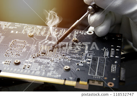 Technician who is repairing circuits, technician repairing and soldering circuits Graphics card repair 118532747