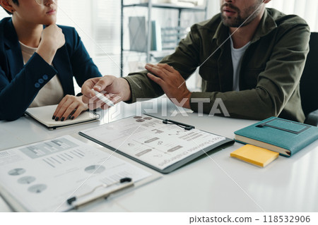 People Discussing Graphs At Meeting 118532906