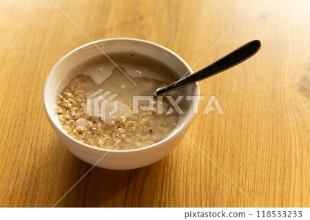 bowl of hot oatmeal on the table 118533233
