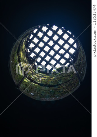 view from the dungeon upwards through a hatch covered with a grate 118533474