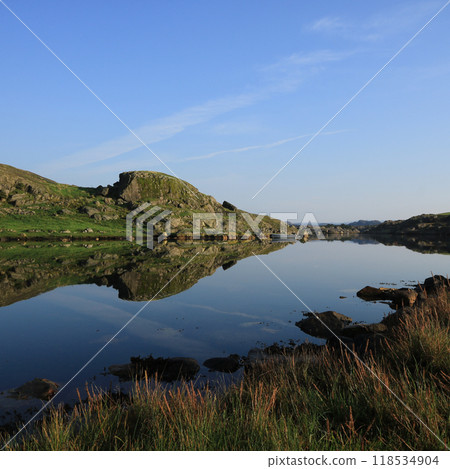 Rock formations reflecting in the sea, Rogaland, Norway. 118534904