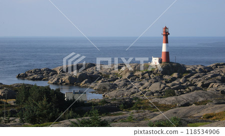 Cast iron Eigeroy lighthouse, rock formations and North Sea, Norway. Cast iron Eigeroy lighthouse, rock formations and North Sea, Norway. 118534906