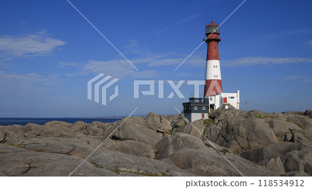 Red and white cast iron Eigeroy Lighthouse and North Sea, Norway. 118534912