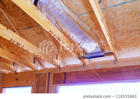 Construction process silver insulation ventilation HVAC pipes are installed on ceiling to roof Construction process silver insulation ventilation HVAC pipes are installed on ceiling to roof 118535063