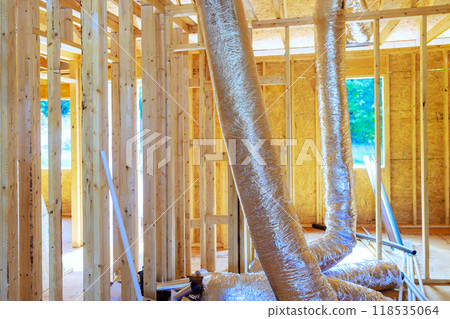 Installing silver insulation ventilation HVAC pipes on ceiling to roof of construction process 118535064