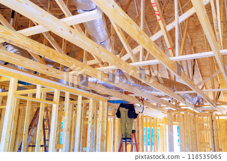 During construction, silver insulation ventilation HVAC pipes were installed from ceiling to roof During construction, silver insulation ventilation HVAC pipes were installed from ceiling to roof 118535065