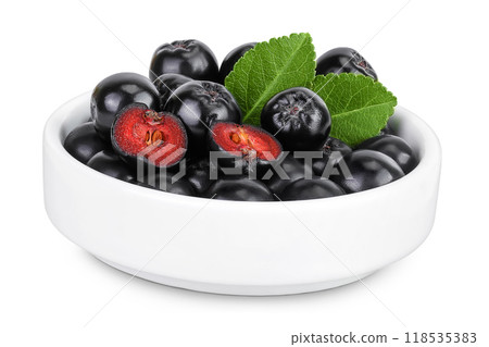 Chokeberry in ceramic bowl isolated on white background. Black aronia. 118535383
