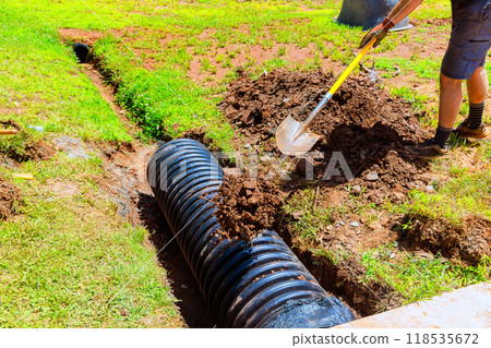 During construction, black drainage pipe is installed in trench During construction, black drainage pipe is installed in trench 118535672